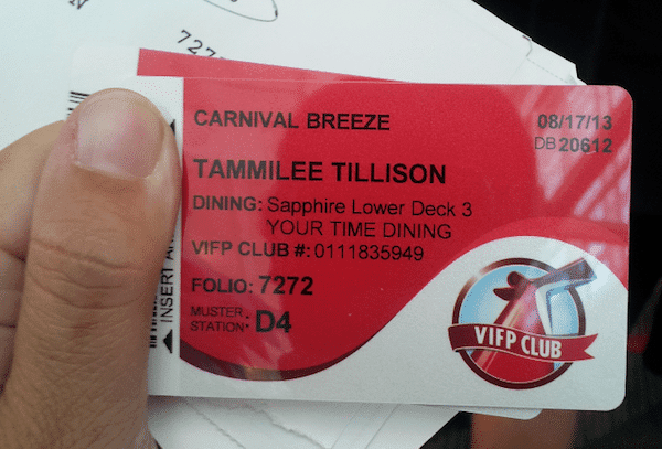 A person proudly holds a VIFP Club card from the Carnival Breeze cruise, displaying the name "Tammilee Tillison," along with dining details for Sapphire Lower Deck 3, muster station D4, folio number 7272, and the date of 08/17/13.