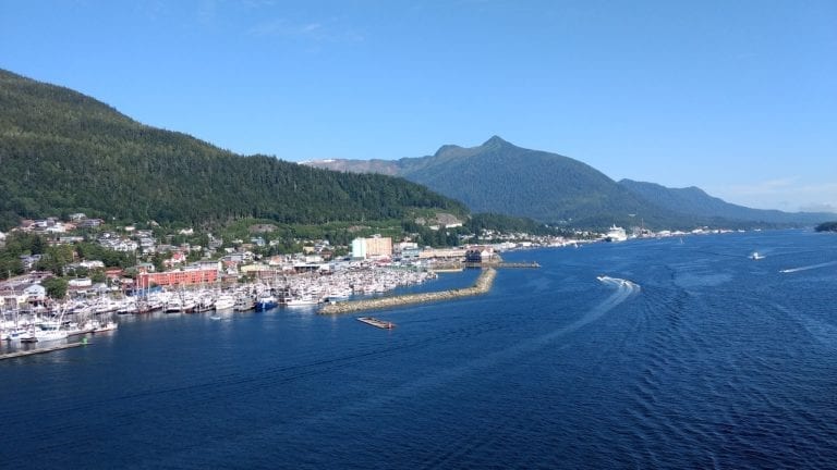 Nestled at the edge of a forested hill, this coastal town offers a vibrant marina where boats dance across the shimmering ocean. With hills and a clear blue sky as its backdrop, it feels like stepping into a scene from the Juneau Cruise Port Guide.