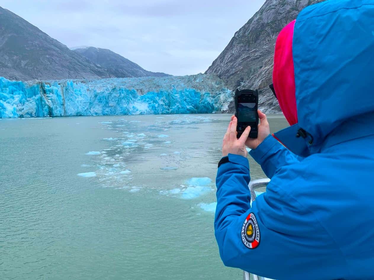 A person taking pictures of glaciers in Alaska