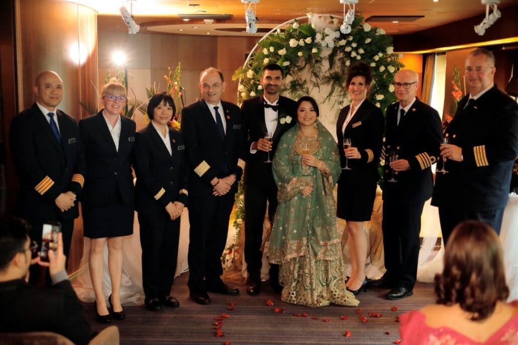 A group of people in formal attire posing for a picture at a Solo Cruises event.