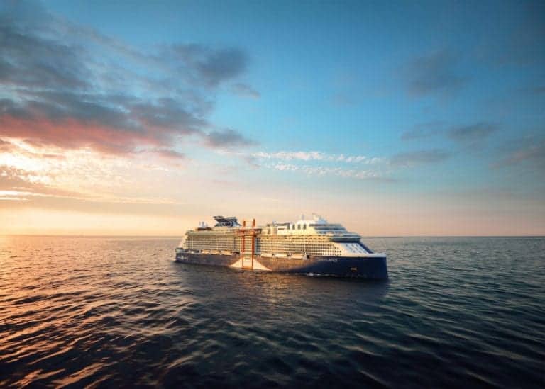 A new cruise ship sails on calm ocean waters during sunset. The sky is partly cloudy with warm hues from the setting sun reflecting on the tranquil sea, adding a touch of magic to this celebrity cruise departing from Florida.