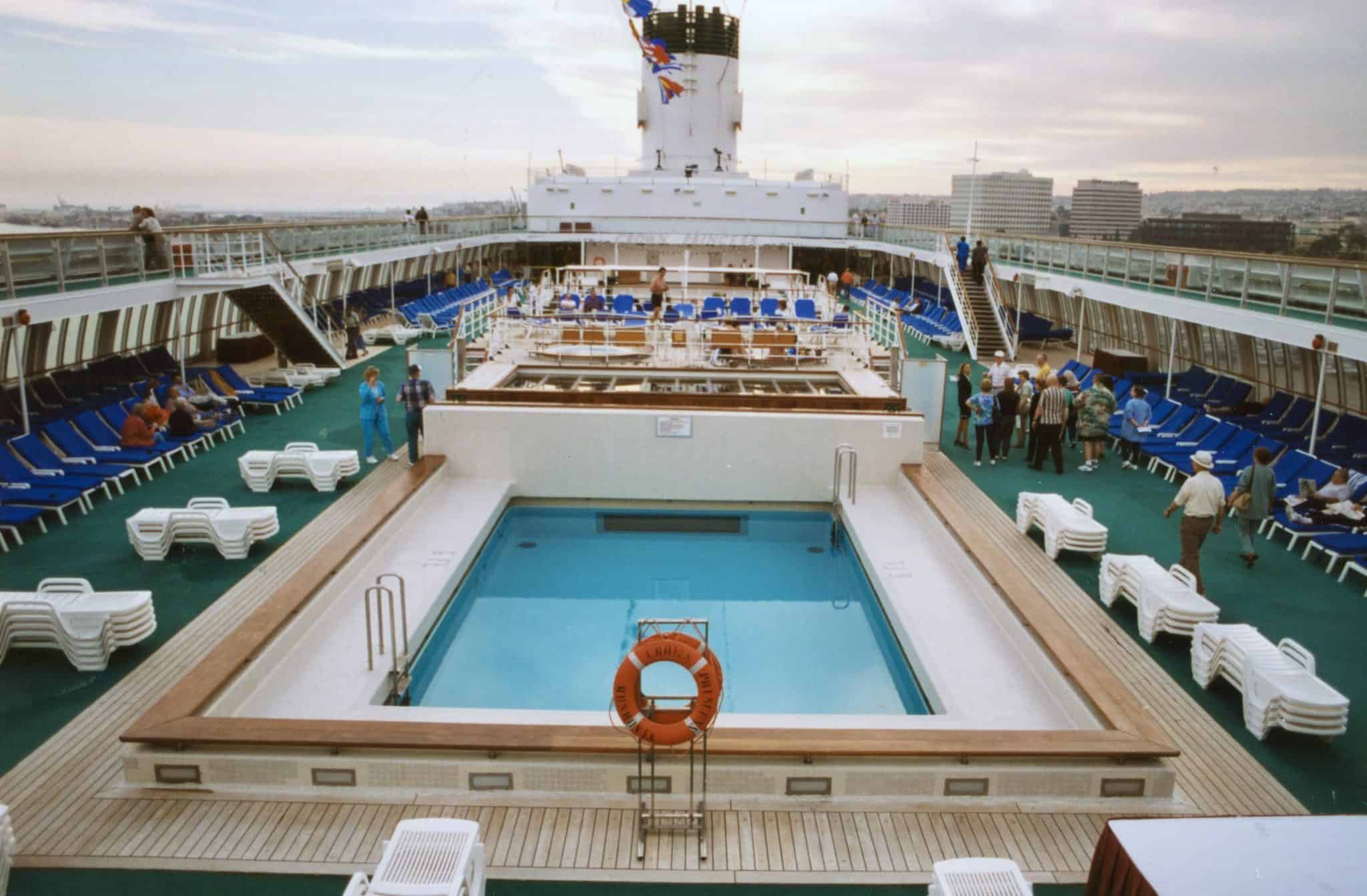 The midships pool and lido as seen from Sun Deck in an aft-facing view