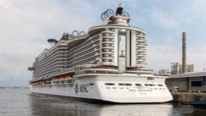 A large MSC Seaside-class ship named "MSC Seaview" is docked at a port, ready to resume voyages. The ship boasts multiple decks with balconies and a pristine white exterior. The name "MSC Seaview" and "Valletta" are visible on the stern, with several lifeboats attached along the side.