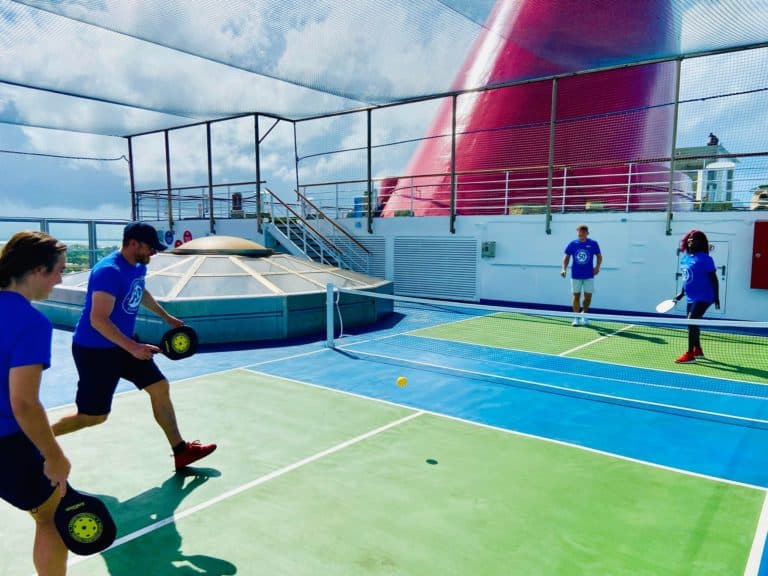 Carnival Conquest crew members playing pickleball