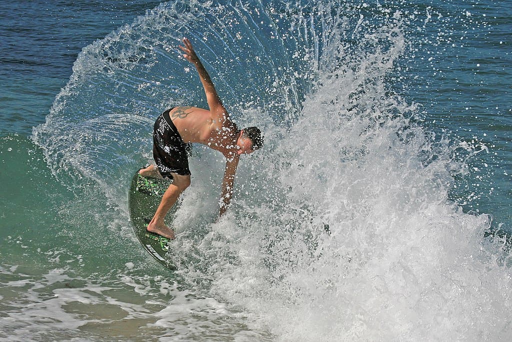 Skimboarding during daytime