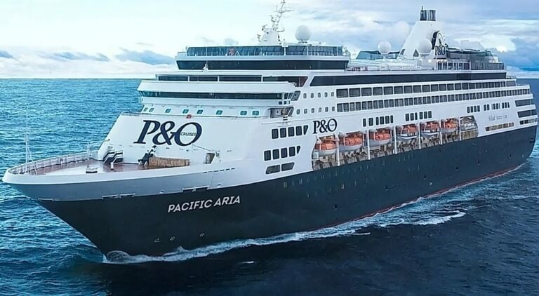 A large cruise ship labeled "Pacific Aria" from P&O Cruises moves through the ocean under a partly cloudy sky, reminiscent of the fleet of Carnival ships sold to eager travelers worldwide.