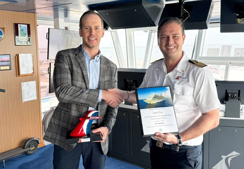 Captain Paolo Severini is joined by David German of the Canaveral Port Authority for a plaque exchange to welcome the Carnival Vista team to Port Canaveral
