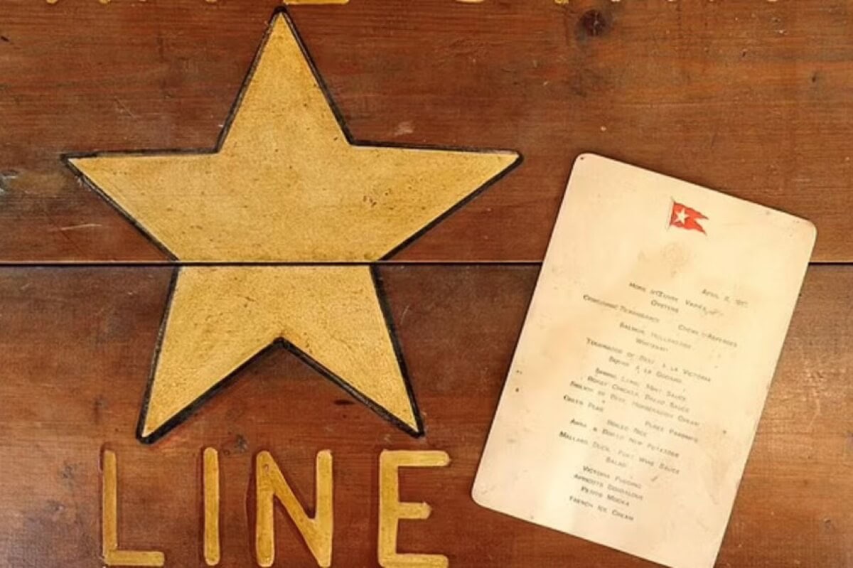 A wooden surface displays a large golden star and the word "LINE" beneath it. To the right, an old card menu evokes memories of maritime legends like the RMS Titanic, featuring a red flag with a white star in its top left corner.
