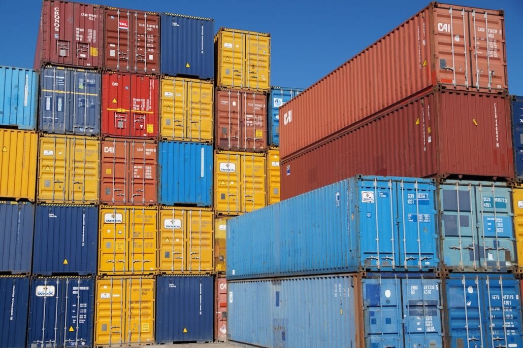 A captivating sight of various shipping containers artfully arranged in a towering stack.