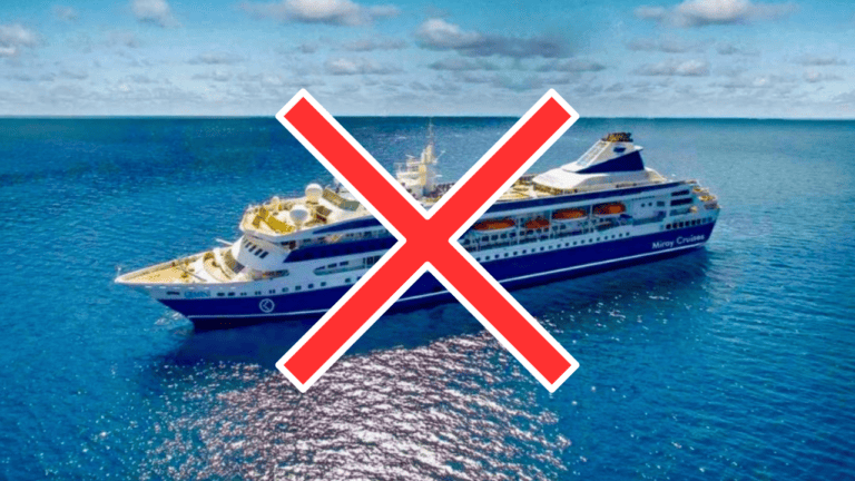 A cruise ship with passengers sailing through the ocean.