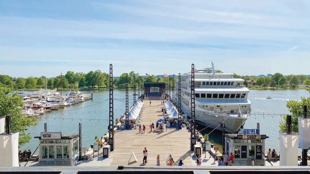 A Washington D.C. cruise ship docked at a small dock.