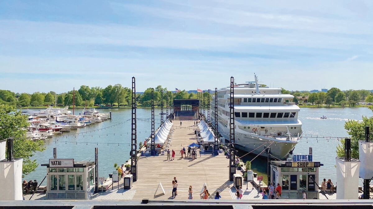 A Washington D.C. cruise ship docked at a small dock.