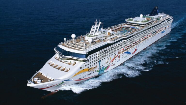 An aerial view of a large cruise ship in the ocean during Venice Port Calls.