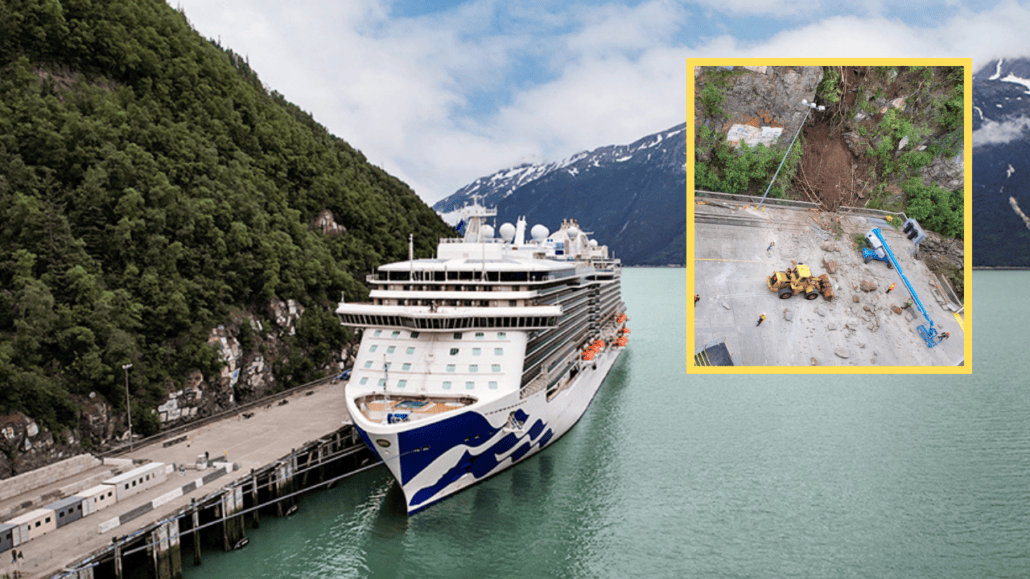 A cruise ship docked at a dock in Skagway with a mountain in the background.