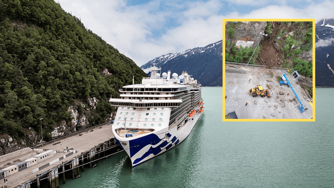 A cruise ship docked at a dock in Skagway with a mountain in the background.