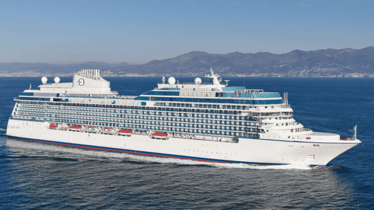 Oceania's large white cruise ship Vista sailing in the Med.
