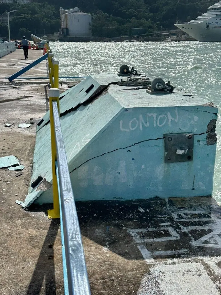 A blue container on the Ocho Rios Port dock next to the water.