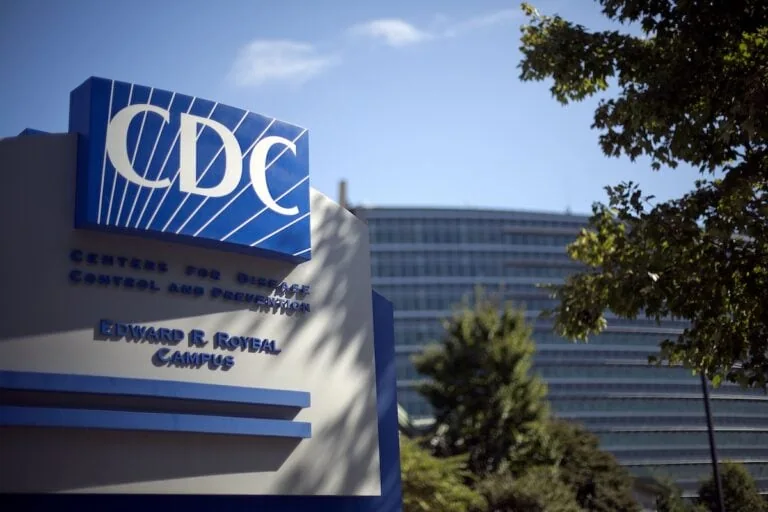 Sign of the Centers for Disease Control and Prevention (CDC) in front of their headquarters in Atlanta, Georgia under a clear blue sky, following reports of a gastro outbreak on a luxury cruise ship.