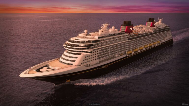A large cruise ship, the Disney Destiny, sails on the ocean at dusk under a purple and orange sky.