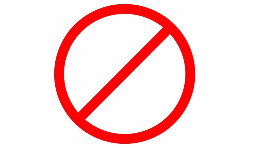 A red prohibition sign featuring a red circle with a diagonal line running from the top left to the bottom right. The background is white, clearly indicating an electronic device ban, with no additional text or symbols within the sign.