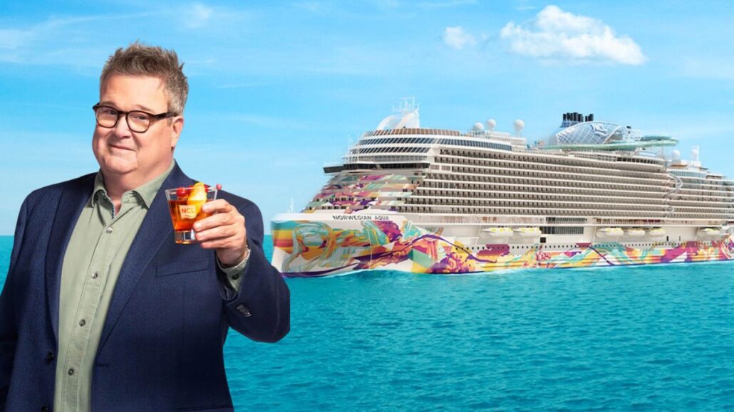 A suited individual holds a drink, poised in front of the Norwegian Aqua cruise ship with its vibrant artwork adorning the hull. Clear blue waters stretch under a bright sky, reminiscent of an extravagant scene straight out of Modern Family.