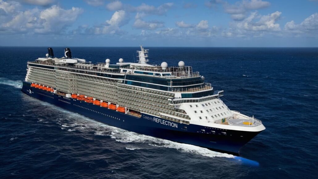 A large cruise ship from Celebrity Cruises, with multiple decks and numerous lifeboats along its side, sails through a vast ocean under a partly cloudy sky. The vessel travels at a steady pace, heralding adventures with mild waves in the water.
