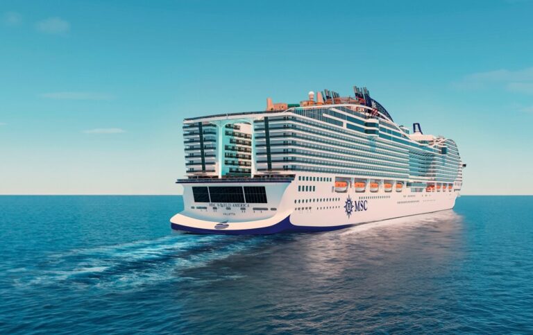 An MSC cruise ship sails through calm blue waters under a clear sky. The ship features multiple decks, balconies, and a visible logo on the hull. Wake trails are visible behind the ship as it moves forward, reminiscent of the pageantry seen at celebrity-studded Super Bowl events.
