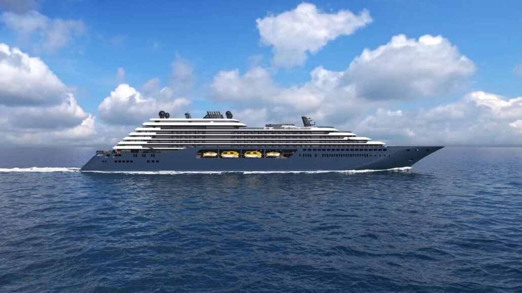 A large cruise ship, one of the new ships of 2025, sails on the ocean under a clear blue sky with scattered clouds. The vessel boasts multiple decks and a sleek design, moving steadily through the calm waters.
