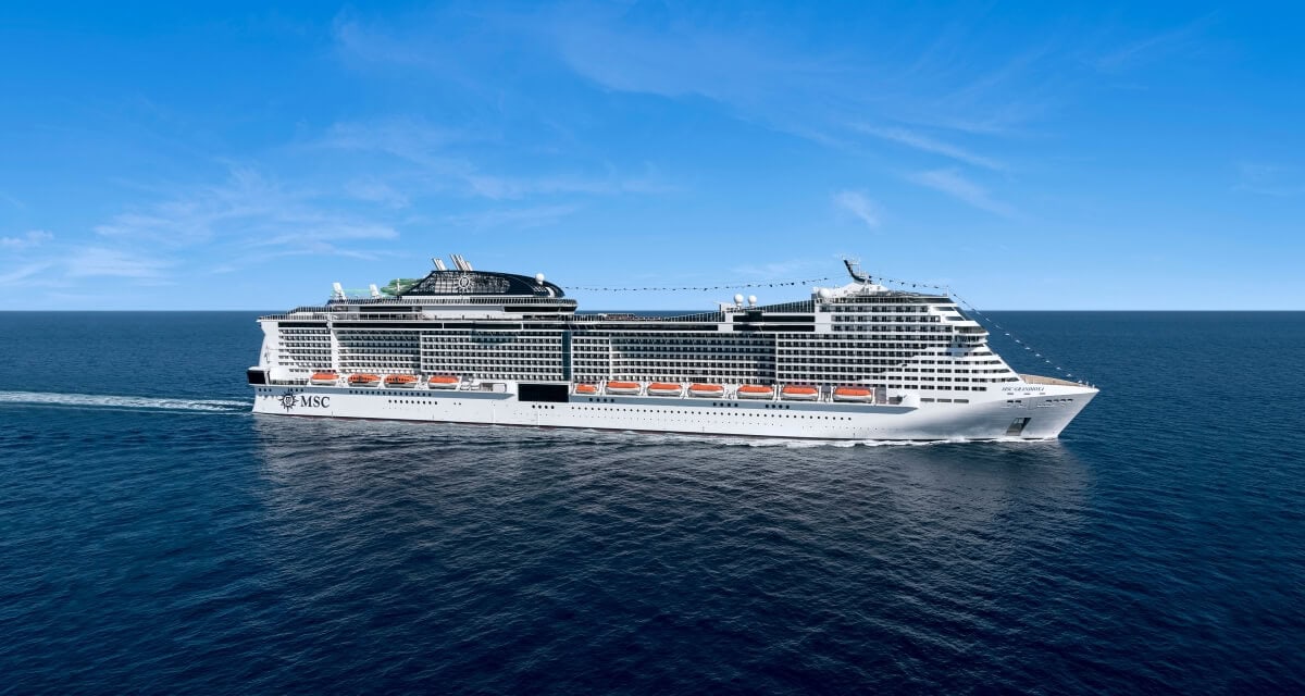 An impressive MSC cruise ship sails gracefully across a calm, blue ocean under a clear sky. This majestic vessel, with its multiple decks and visible lifeboats, makes its way toward Port Canaveral's welcoming shores.