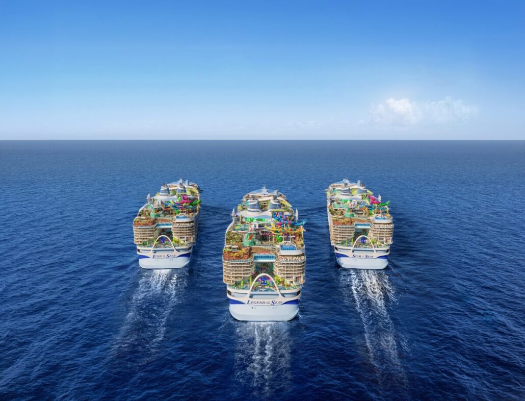 Four Icon-Class ships sail side by side on a calm ocean under a clear blue sky. Each Royal Caribbean ship features multiple decks with various structures and decorations, as they move forward leaving trails in the water.