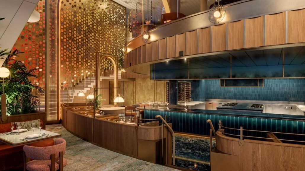 The Bazaar's interior boasts a contemporary design with circular wall patterns, a teal tiled open kitchen, wooden accents, and cozy seating. A staircase with decorative panels leads to an upper level. Ambient lighting adds warmth to this destination-focused cruising experience.