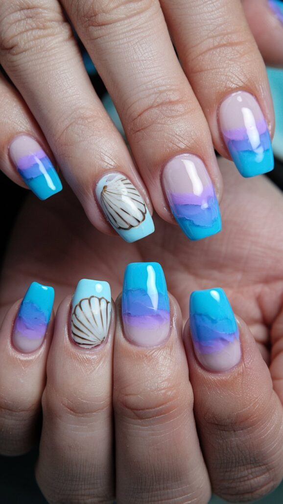 Close-up of hands showing manicured nails, perfect for a Bahamas cruise. The nails boast a gradient design in blue and purple shades, with two featuring a white seashell pattern on a natural background. These glossy, square-shaped gems showcase one of the best designs for your next tropical getaway.