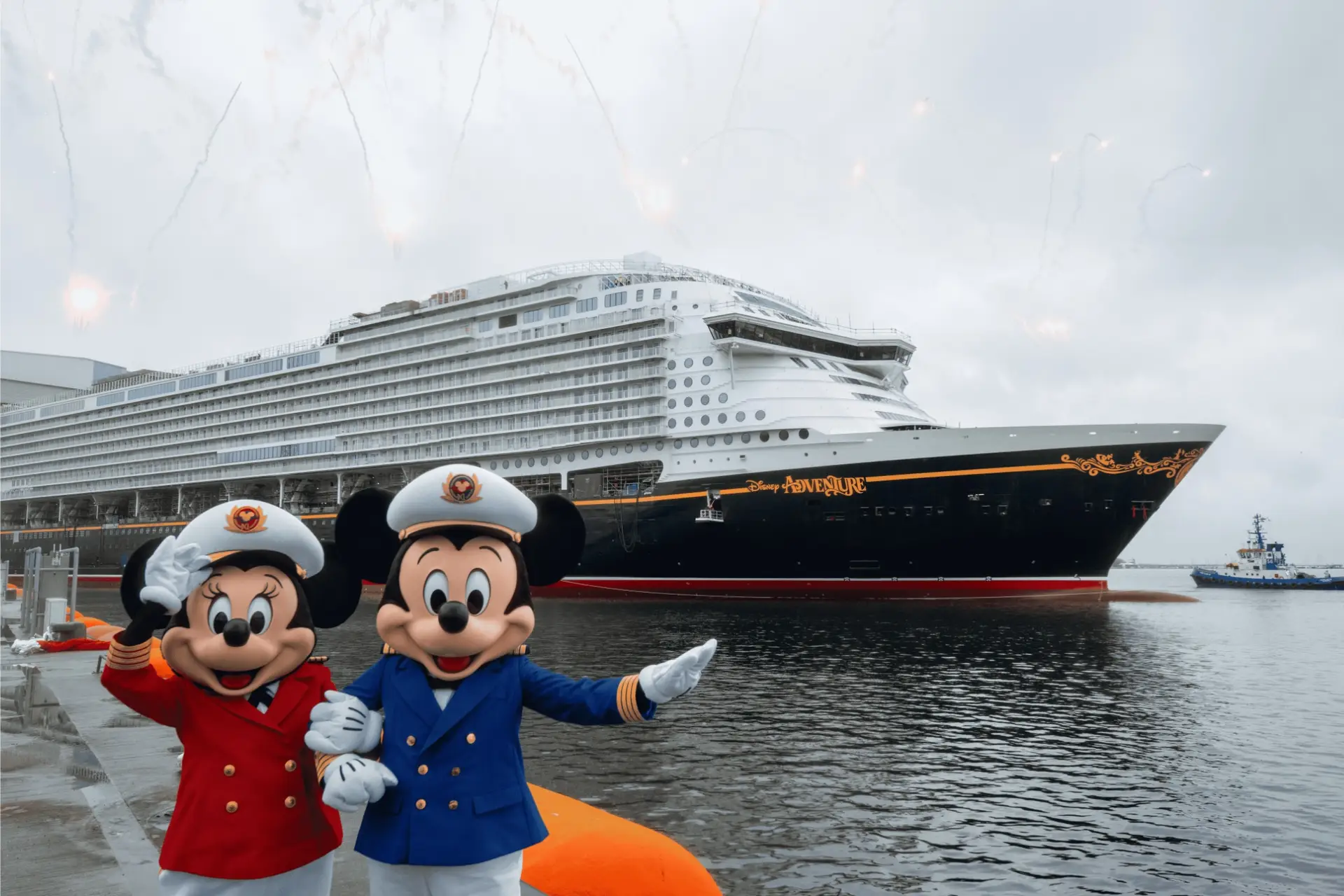 Two people in Mickey and Minnie Mouse costumes dressed as ship captains stand on a dock before the Mega Ship Disney Adventure, a proud addition to the Disney Cruise Line, with overcast skies and faint fireworks in the background.