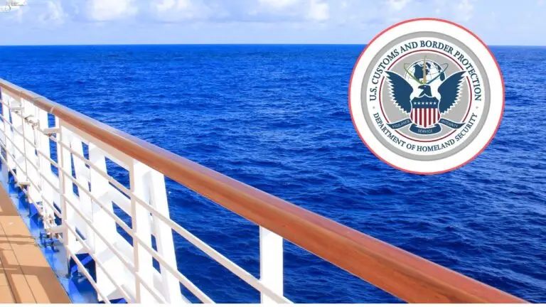 A cruise passenger stands by a wooden handrail overlooking the calm, blue ocean. The U.S. Customs and Border Protection seal appears in the corner, suggesting potential denied entry for some travelers.