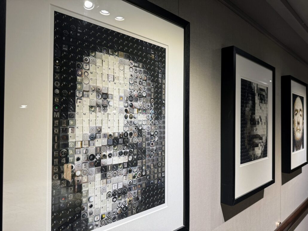 Three framed portraits hang on a wall. Each mosaic, crafted from keyboard keys, forms human faces—an unexpected art style reminiscent of the innovative spirit aboard a Holland America Alaska cruise on the Koningsdam.