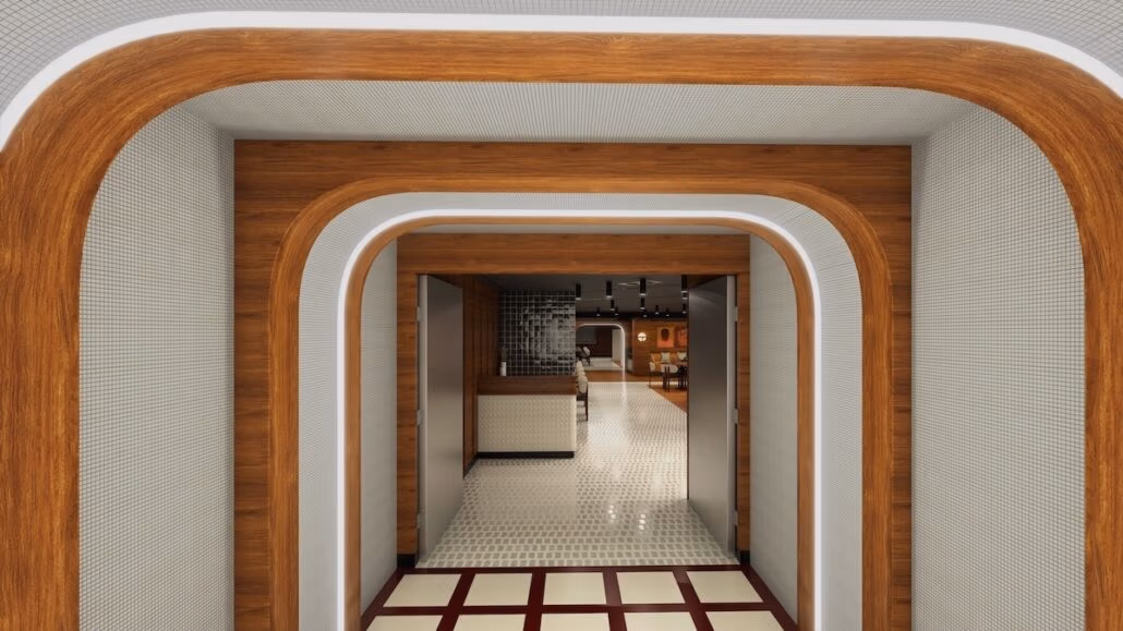 A modern hallway with curved wooden arches, white walls, and a tiled floor leads to an open area with a seating arrangement reminiscent of a Spanish tapas bar. Subtle lighting accentuates the design elements, echoing the sophisticated vibe of Virgin Voyages' Brilliant Lady.