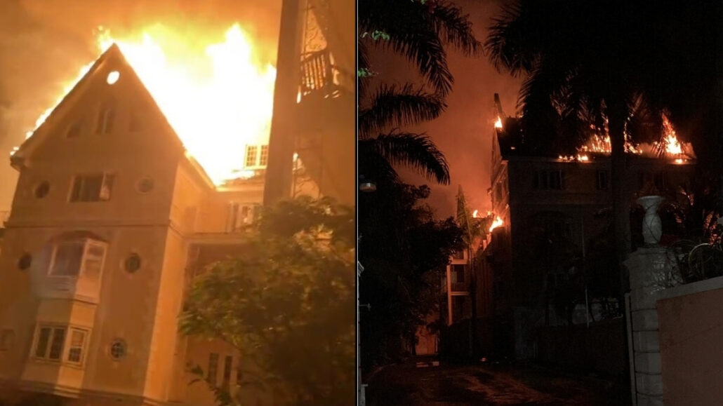 A large multi-story building is engulfed in flames at night near the Cruise Port. The photo is split into two views: one shows the Nassau Blaze from the front with bright flames, while the other shows the fire lighting up downtown buildings from the side.