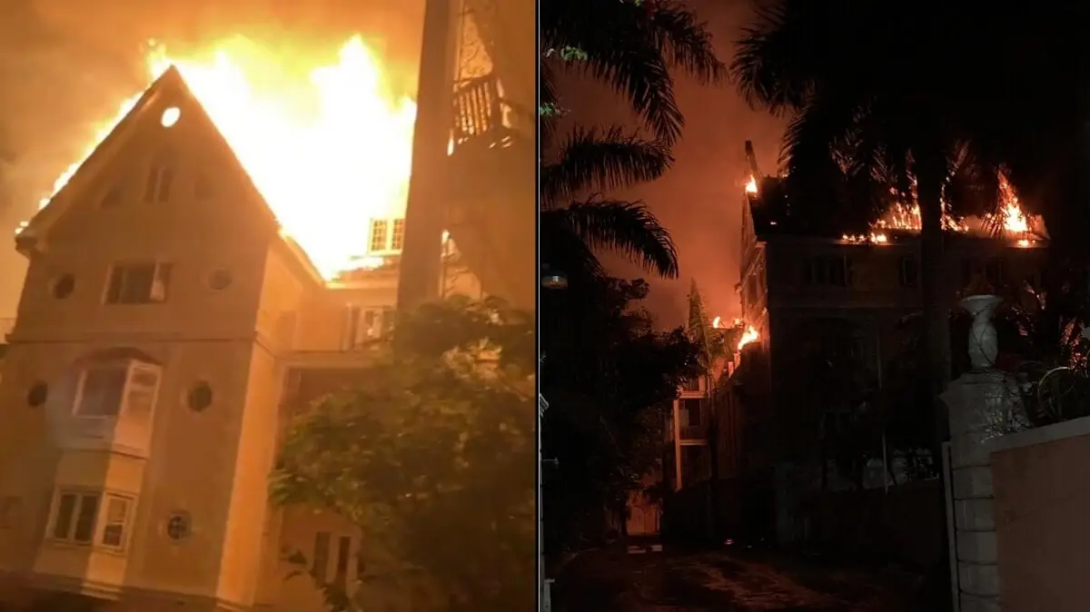 A large multi-story building is engulfed in flames at night near the Cruise Port. The photo is split into two views: one shows the Nassau Blaze from the front with bright flames, while the other shows the fire lighting up downtown buildings from the side.