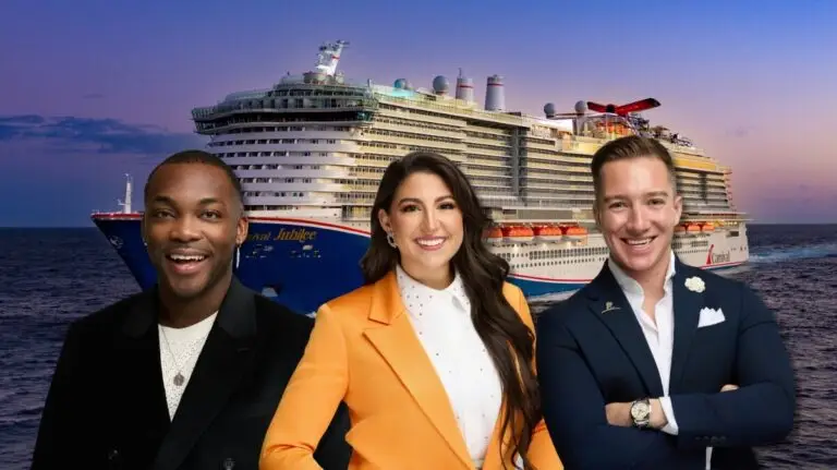 Three people, two men and one woman, stand smiling in front of a large Carnival cruise ship on the ocean at sunset. The woman wears an orange blazer; the men wear dark jackets, perhaps awaiting the 2025 Carnival Cruise Director Schedule.