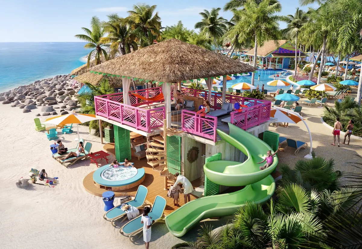A tropical beach scene with a two-story cabana featuring pink railings, a thatched roof, a green spiral slide, a hot tub, people relaxing on lounge chairs, and palm trees under a clear sky.