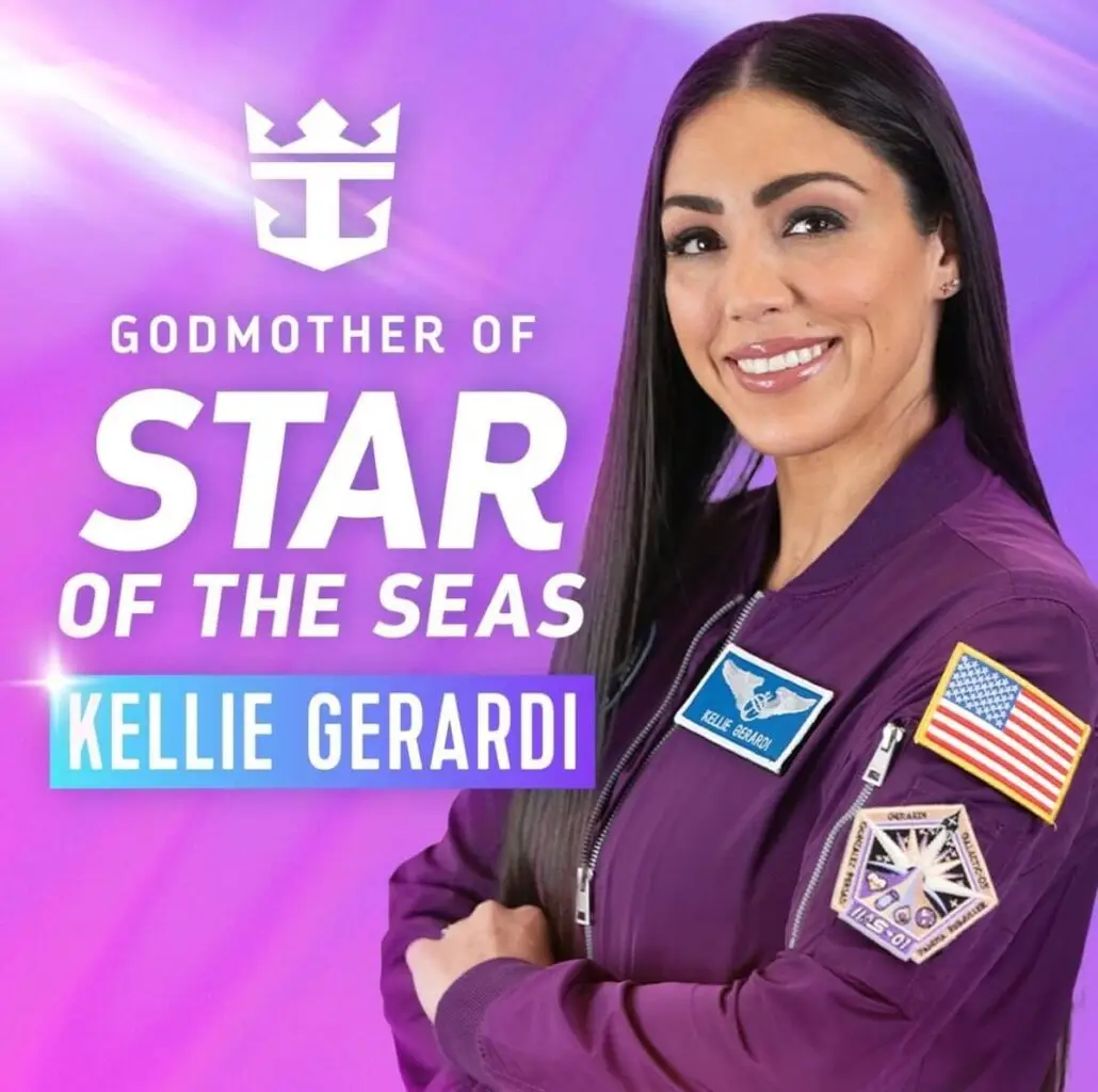 A woman with long dark hair in a purple jacket stands before a purple background. Text reads: "Godmother of Star of the Seas, Kellie Gerardi." The jacket, marked with astronaut patches and her name, hints at Royal Caribbean’s adventurous spirit.