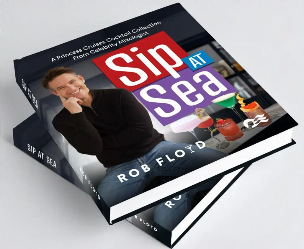 The image shows two stacked copies of “Sip at Sea” by Rob Floyd. The cover features the celebrity mixologist’s smiling face, vibrant cocktails, and highlights this Princess Cruises cocktail collection.