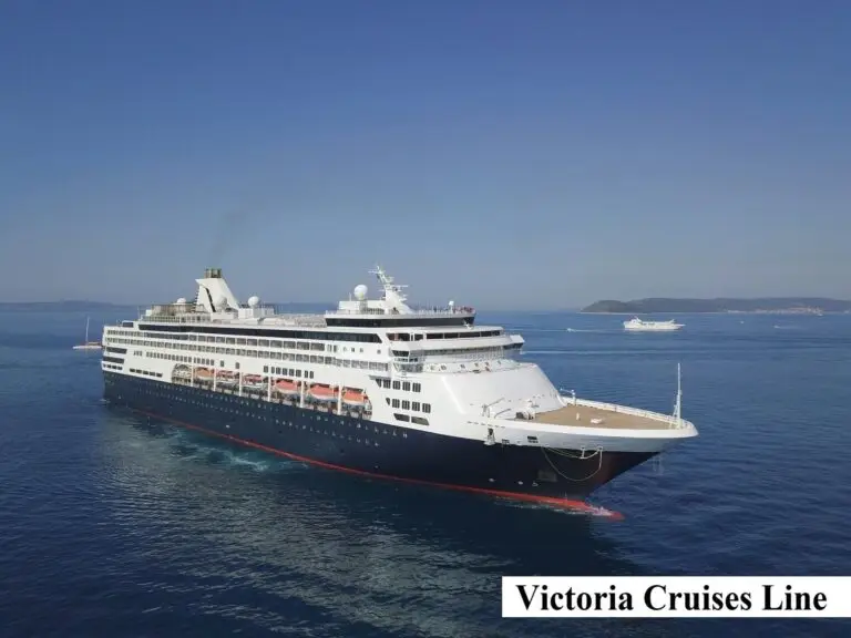 A large cruise ship sails on calm blue water under a clear sky, with a smaller boat in the background. The text "Victoria Cruises Line" appears in the lower right corner, highlighting this unique three-year cruise experience.