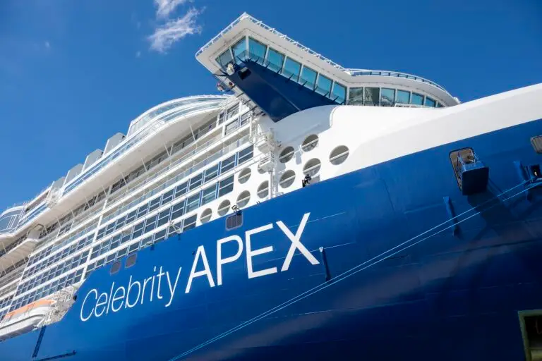 Close-up view of the Celebrity Apex cruise ship’s blue and white exterior, several rows of windows, and the bridge against a clear blue sky—perfect for Seven-Night Cruises from Florida's Space Coast.
