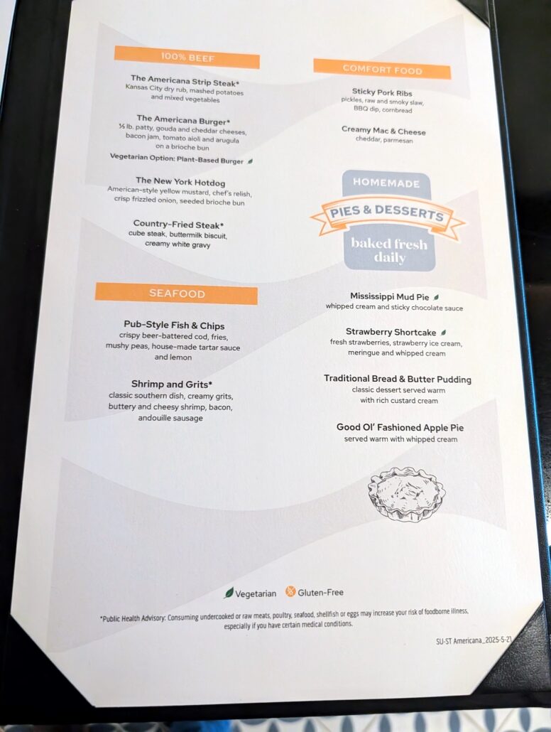 A restaurant menu on a black surface displays sections for beef, comfort food, seafood, and pies & desserts. Star Princess dining options are noted with vegetarian and gluten-free symbols below, along with a food allergy warning.