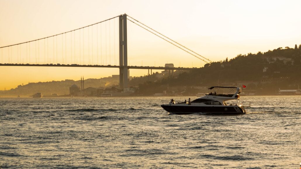 A private yacht cruising the Bosphorus strait at sunset in Istanbul