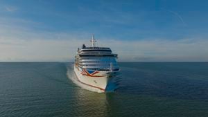 A large Queen Anne cruise ship sailing on the open sea.