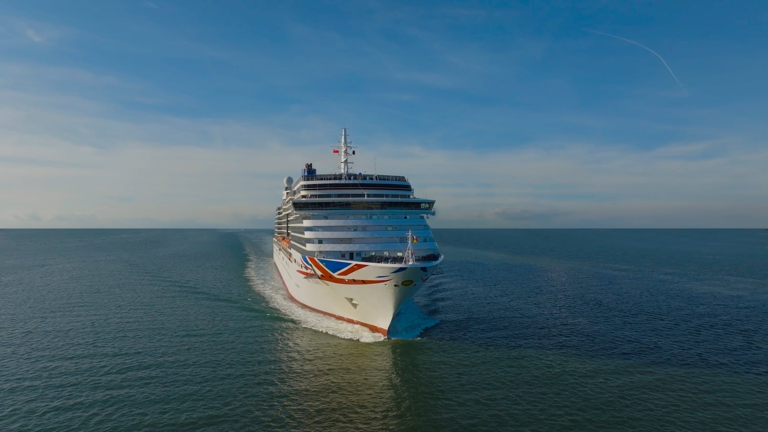 A large Queen Anne cruise ship sailing on the open sea.