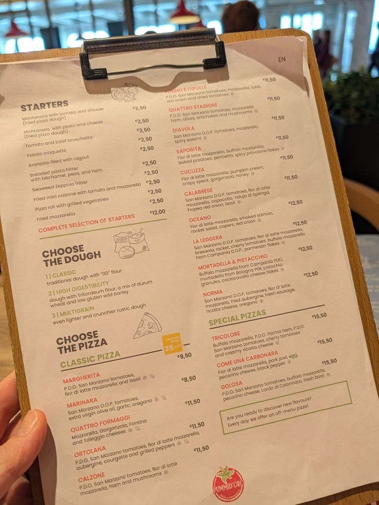 A pizza restaurant menu featuring starters, dough choices, and classic and special pizzas with prices in euros, found in the Costa Toscana cruise guide.